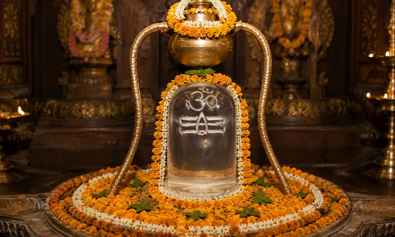 Sphatika Lingam being offered abhisheka with milk inside a temple sanctum